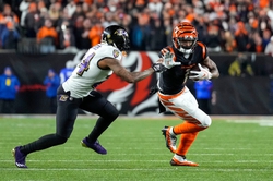 Bengals wide receiver JaMarr Chase (1) stiff-arms former Baltimore Ravens cornerback Marcus Peters (24) during 2023 NFL wild-card playoff football game.