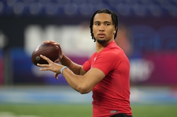 Mar 4, 2023; Indianapolis, IN, USA; Ohio State quarterback C J Stroud (QB12) participates in drills at Lucas Oil Stadium. Mandatory Credit: Kirby Lee-USA TODAY Sports