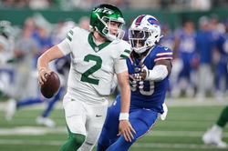 Sep 11, 2023; East Rutherford, New Jersey, USA; New York Jets quarterback Zach Wilson (2) avoids being sacked by Buffalo Bills defensive end Shaq Lawson (90) during the second half at MetLife Stadium. Mandatory Credit: Vincent Carchietta-USA TODAY Sports