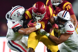 Oct 7, 2023; Los Angeles, California, USA; Southern California Trojans running back MarShawn Lloyd (0) is brought down by Arizona Wildcats linebacker Jacob Manu (5) and linebacker Taylor Upshaw (11) during the second half at Los Angeles Memorial Coliseum. Mandatory Credit: Gary A. Vasquez-USA TODAY Sports