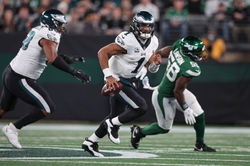Oct 15, 2023; East Rutherford, New Jersey, USA; Philadelphia Eagles quarterback Jalen Hurts (1) scrambles in front of New York Jets defensive end Carl Lawson (58) during the second half at MetLife Stadium. Mandatory Credit: Vincent Carchietta-USA TODAY Sports