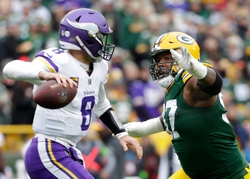 Green Bay Packers defensive tackle Kenny Clark (97) pressures Minnesota Vikings quarterback Kirk Cousins (8) at Lambeau Field in Green Bay, Wis. Minnesota defeated Green Bay 24-10 but lost Cousins for the remainder of the season.  Wm. Glasheen USA TODAY NETWORK-Wisconsin