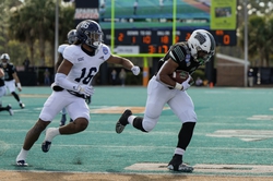 Dec 16, 2023; Conway, SC, USA; Ohio Bobcats running back Rickey Hunt (28) scores a touchdown ahead of Georgia Southern Eagles defensive back Tyrell Davis (16) in the first half against the Georgia Southern Eagles at Brooks Stadium. Mandatory Credit: David Yeazell-USA TODAY Sports