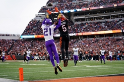 Cincinnati Bengals wide receiver Tee Higgins (5) catches a touchdown pass over Minnesota Vikings cornerback Akayleb Evans (21) in Cincinnati's comeback win over Minnesota in overtime, 27-24, Saturday, Dec. 16, 2023, at Paycor Stadium in Cincinnati. The Cincinnati Bengals won 27-24 in overtime.