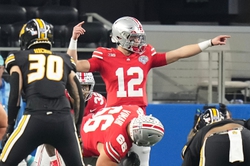 Dec 29, 2023; Arlington, Texas, USA; Ohio State Buckeyes quarterback Lincoln Kienholz (12) motions at the line of scrimmage during the second quarter of the Goodyear Cotton Bowl Classic against the Missouri Tigers at AT&T Stadium.