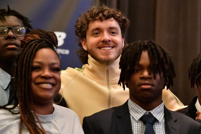 Jack Harlow, center, poses with kids that are the recipient of a new pair of New Balance shoes at the United Way offices, Tuesday, Nov. 28 2023 in Louisville Ky.