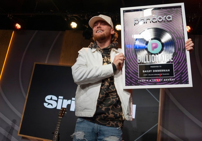Bailey Zimmerman, is presented with a framed record for his billion pandora streams while doing an interview, at Sirius XM Studios in Nashville, Tenn., Thursday, Oct. 17, 2024.